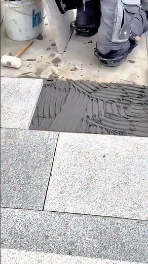 Granite tile installation using adhesive mortar for durable and precise surface finishing