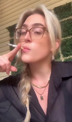 Stunning blonde woman smoking a cigarette