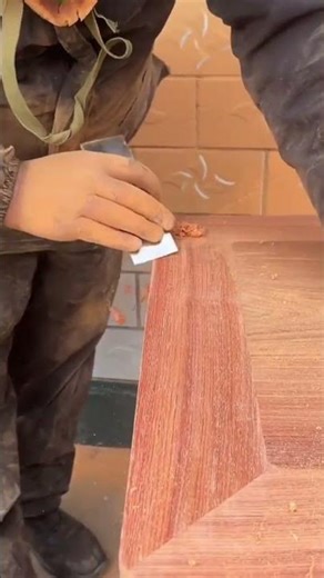 scraping the wooden table surface precisely using a professional manual metal wood scraper tools