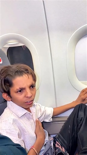 The boy has boarded a plane for the first time.