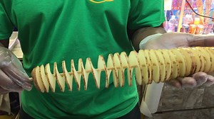 This machine turns a potato into a swirly french fry on a stick. | Insider