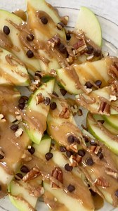 These apple nachos are a fun and healthy snack that’s easy to make. Sliced apples are piled high and topped with date caramel sauce, nut butter, chocolate chips and chopped nuts. | Eating Bird Food