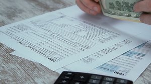 Filling 1040 Tax Form and Taxes Document on Table in Office. Individual Income Tax Return. Tax payment time Concept