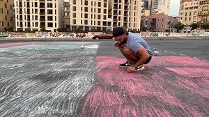 8.6K views · 237 reactions | Lebanese painter @bassilgiovanni Giovanni Bassil aims to break the Guinness world record for the world's largest flag, as he draws a 200 square metre pavement chalk Lebanese flag in downtown Beirut. He says he aims to send a message of "hope" to his country, which is mired in an unprecedented economic and social crisis. Courtesy of AFP News Agency | We Are Lebanon | Facebook