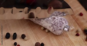 Cutting sausage with white mold, slicing salami with mold pieces for table setting