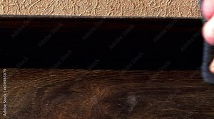 Dust cleaning. Dusting with a cloth. Slow motion. Wiping off the dust with a rag. Hand wipes dust from the plinth. Cleaning, disinfection a dirty house. Heavy pollution of the apartment. Close-up