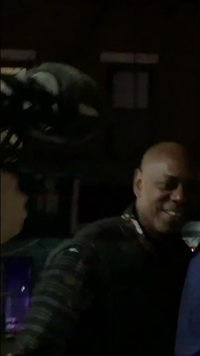 Dave Chappelle walks down the street filming #cocnc