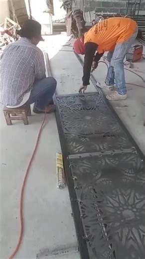 Work on making a perforated iron fence