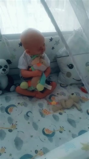 Adorable Child Interacting with Colorful Stuffed Toys