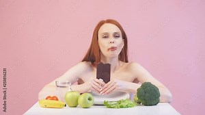 Happy anorexic girl greedily eats chocolate. Violation of diet. Poor diet. Anorexia.