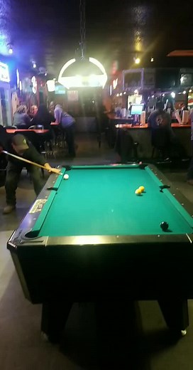 Pool Playing Techniques in a Cozy Bar Setting