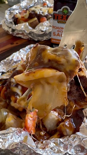 #sponsored Foil Packets are a family favorite dinner all summer long! @Texas Roadhouse INGREDIENTS 1 lb ground beef Steak seasoning Texas Roadhouse Gold Sauce 4 potatoes 1 onion 1/2 bag baby carrots Olive oil Shredded Colby Jack cheese INSTRUCTIONS Form ground beef into 4 equal size patties. Wash and chop potatoes into cubes. Chop an onion. Slice baby carrots in half. Lay out a couple of pieces of aluminum foil. Add one chopped potato, a handful of onion and some baby carrots. Drizzle a little b
