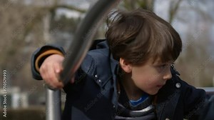 Child spinning on roundabout play carousel at park during autumn season, kid circling around in motion outdoors Stock Video
