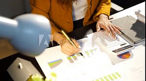 Business women in the night office working overtime are stressed by overwork and worrying about deadlines.