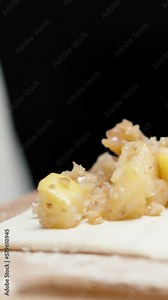 I spread the filling of quince and walnut on puff pastry, close-up. Pies. Vertical video Social Media