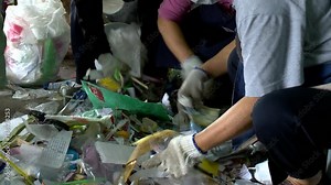 People sorting garbage for recycling