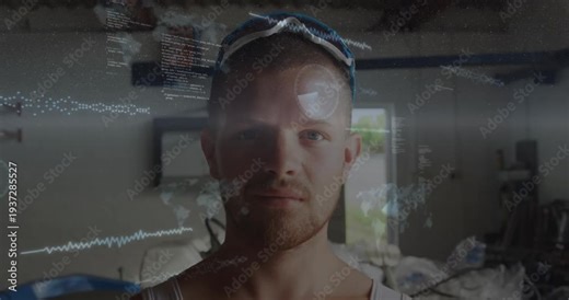 Man standing facing camera in workshop, waveform sweep initiating HUD overlays for technology demo