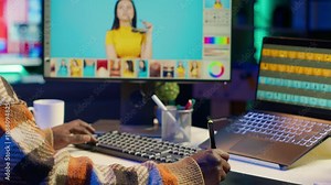 Remote graphic designer using advanced editing software to retouch images, embodying creativity and technological power of the digital art industry. Retouching work at home. Camera A.
