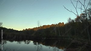 Time lapse video of nightfall over Canadian lake and treeline