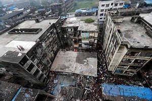 At least 13 dead, 25 feared trapped, in India building collapse