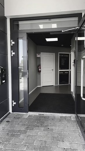 Muscular Man Exiting Modern Building with Style