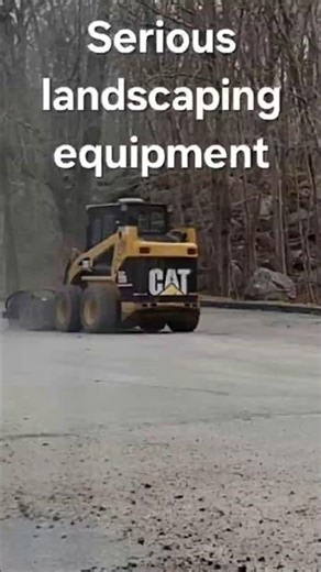 Cat 226B skid steer loader with cold planer attachment for asphalt