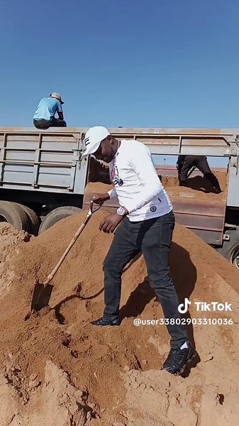 Manual Labor: Sand Shoveling for Truck Loading