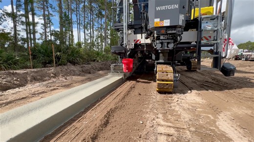 Pouring curb with our new, Wirtgen SP 33. This is the first SP 33 in North America running Leica Geosystems, which replaces traditional stringlines with a 3D digital model for precise, automated concrete paving. The Leica system calculates the machine's exact position and elevation in real time and sends correction data to the paver's hydraulics to ensure the finished profile matches the design specifications. Beard Equipment Company Wirtgen Group Leica Geosystems Major Concrete #3DConcreteSolut