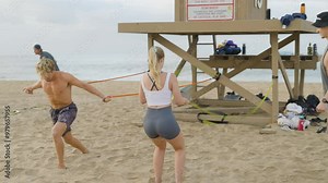 Couple doing crossfit exercises at the beach