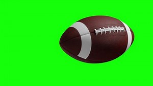 American football Rotating in Motion on Green Screen. Looped American football 3d Animation of Turning Ball luma key black-white alpha
