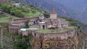 Medieval Armenian architecture of Tatev Monastery on rustic cliff edge