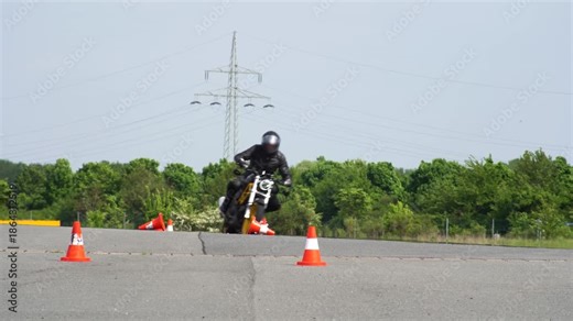 Motorcycle Rider Leaning Through Cone Slalom on Test Track | Rider Training & Cornering Maneuver Test field — dynamic riding/skill training, safety and maneuvering demonstration.