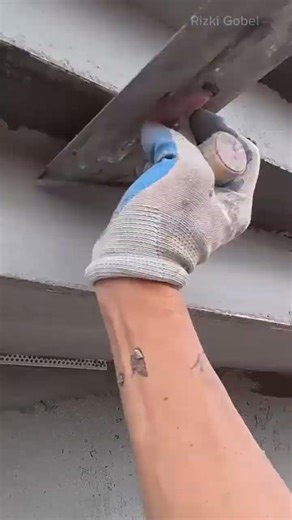 Installing metal corner beads on a concrete wall for reinforcement