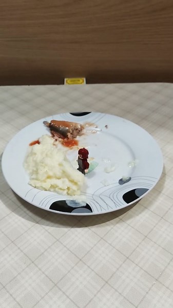 Either the little man is eating mashed potatoes.