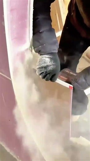 cutting a hole into a purple wall using a handheld power oscillating tool #shorts