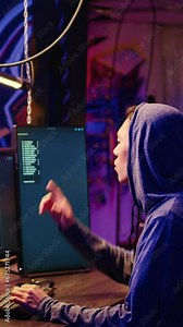 Vertical video Hackers developing zero day exploit undetectable by antivirus software installed on systems in order to steal valuable data from users. Rogue programmers in hideaway look for ways to