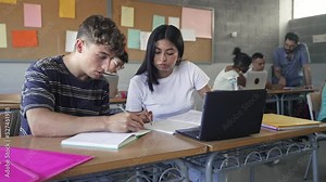 Teenager classmates friends doing exercise and working together in the Secondary School Classroom - Multi ethnic caucasian and Latin American students