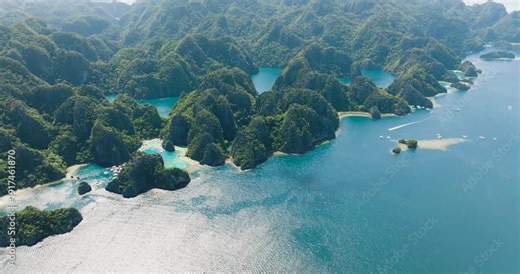 Scenic landscape of Kayangan Lake and Barracuda Lake. Boats running over the blue sea and lagoons. Coron, Palawan. Philippines.