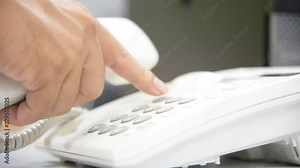Close up businessman use telephone dialing in office