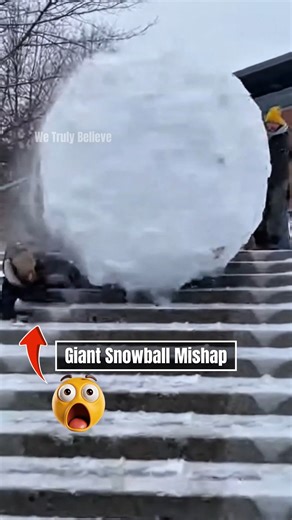 We Truly Believe on Instagram: "9:22am in Canada 🇨🇦 Giant Snowball Mishap Students at a university campus witnessed a hilariously chaotic moment when a group attempted to roll an impossibly GIANT snowball down a long outdoor staircase. What began as harmless fun quickly escalated as the massive snowball gained momentum, bouncing step by step and sending snow flying in every direction. Footage shows students shouting, laughing, and scrambling to the sides—while one unlucky student briefly gets 