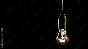 Super slow motion light bulb glows. On a black background.Filmed on a high-speed camera at 1000 fps.High quality FullHD footage