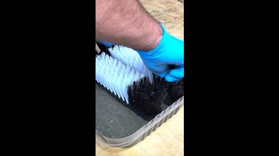 Stick Dollar Tree broom heads into concrete...