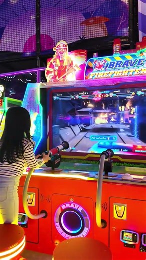 Giera Trying a Firefighter Arcade Game