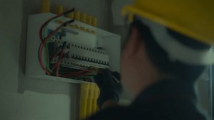 clip-3570877897-electrician-using-electric-screwdriver-tester-check-current