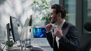 Happy Caucasian adult man working with computer pc reading good news victory winner male winning employee guy business joyful businessman success manager office worker win executive achieve celebrate