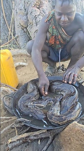 Dudukwe preparing bush python meat