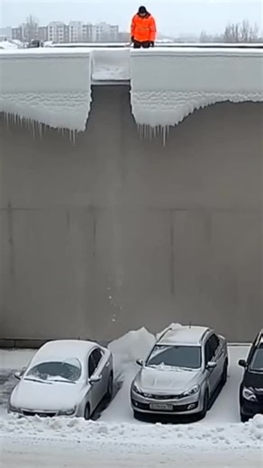 Rahul Nanda on Instagram: "After a once-in-146-years Russian snowstorm, fate selected one brave soul to perform extreme ice chiseling above a row of innocent parked cars. It began gently, with polite ice crumbs tapping roofs like warning knocks. Then the glacier-sized chunk detached, obeying gravity with zero mercy. Cars folded instantly, alarms screaming like startled birds. Snow dust rose. Time slowed. The man froze, tool mid-air, realizing this job description definitely skipped a few bullet 