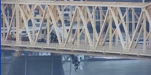 Tractor-trailer dangles from bridge over Ohio River; driver rescued