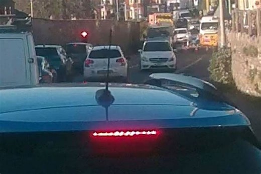 Driver speeds through red light and fails to stop before crashing into oncoming traffic