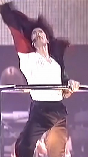 During Michael Jackson’s HIStory World Tour stop in Seoul, South Korea in 1996, one unforgettable moment unfolded mid-performance of Earth Song. As the King of Pop ascended on a mechanical lift during the song’s dramatic peak, a daring fan suddenly rushed the stage—and climbed right onto the lift with him. What could’ve been a chaotic interruption turned into a strangely cinematic moment. Instead of panicking, Michael instinctively held onto the fan, securing him as the platform continued its as
